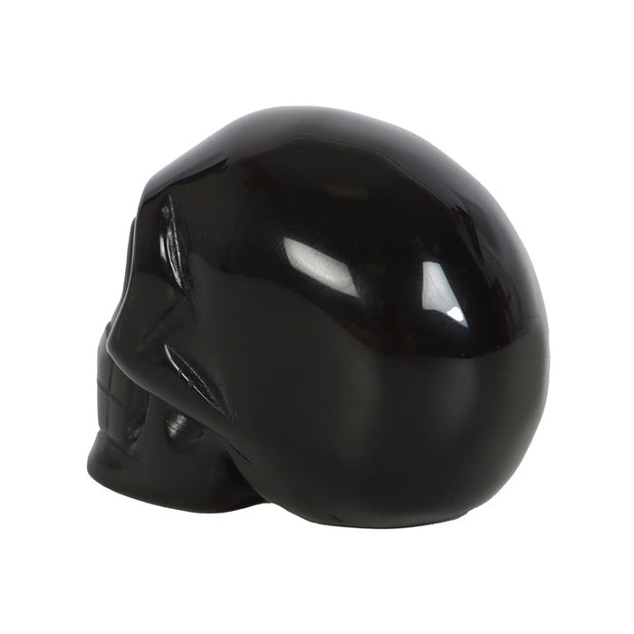 rear view of black obsidian crystal skull highlighting smooth carved finish