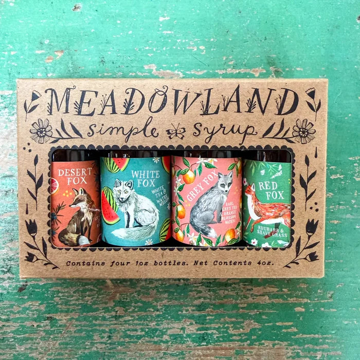 Meadowland simple syrup packaging with four bottles on a textured green background