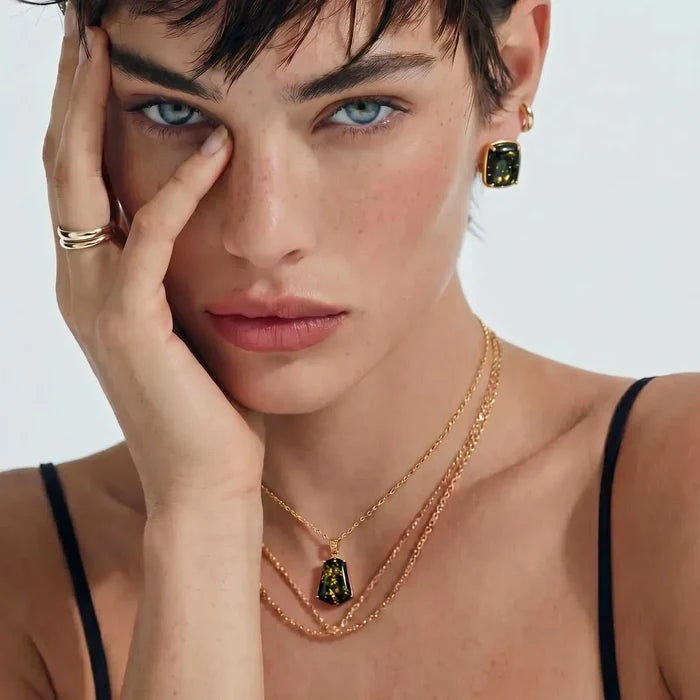 Forest Gold Green Amber Pendant Necklace with a dark green and gold-flecked trapezoid stone in a gold-tone setting on a fine chain