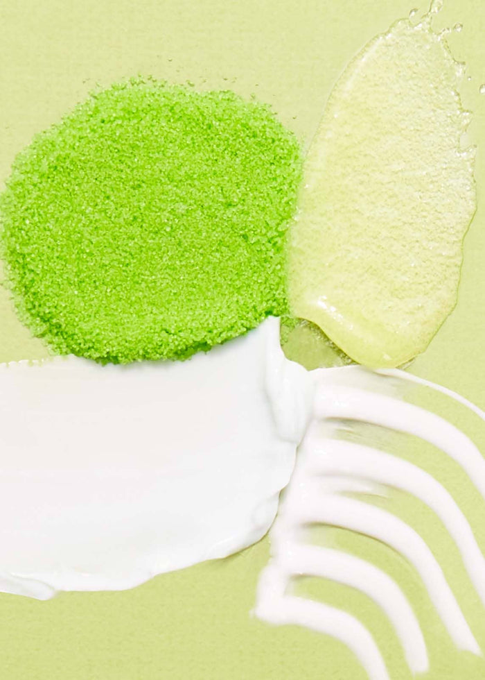cosmetic swatches against light green background