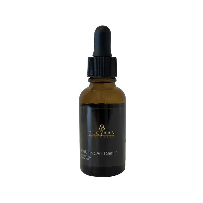 Hyaluronic Acid Serum in an amber glass dropper bottle with a black label, ribbed cap, and pipette top