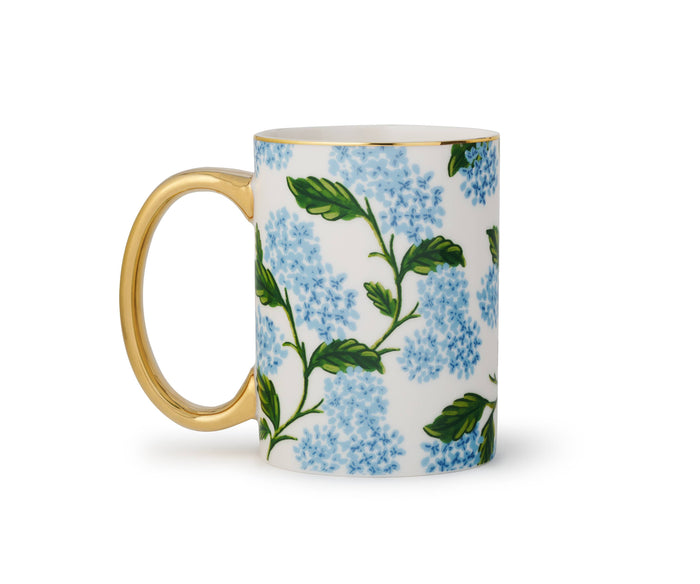 Mug with floral design and gold handle on a white background