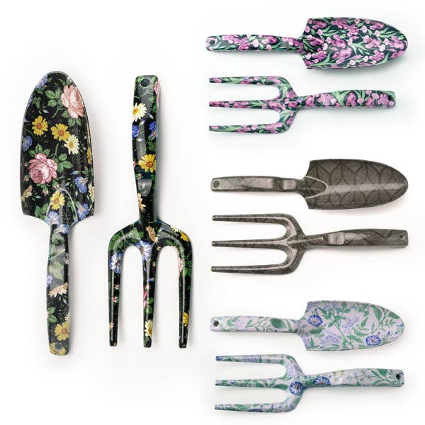 A collection of gardening tools with floral patterns, including a shovel, rake, and other hand tools.