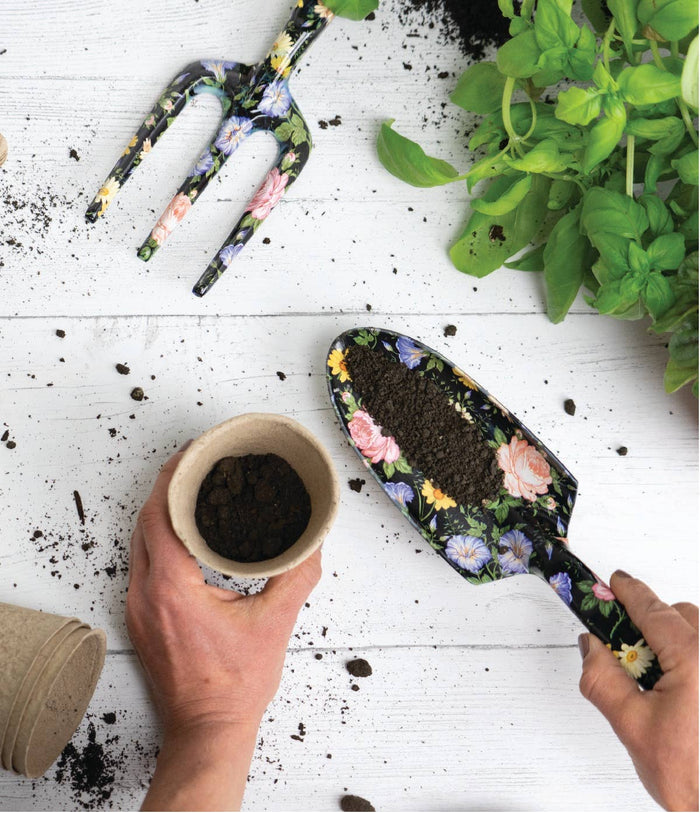 person using floral gardening tools