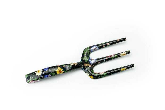 black floral gardening rake on white background