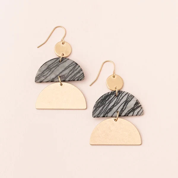 Pair of earrings with gold and marbled gray design on a beige background