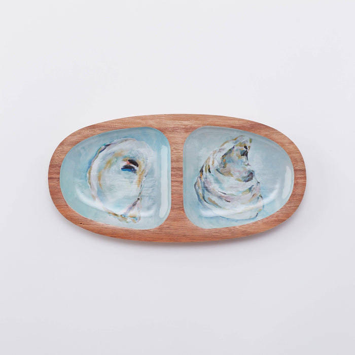 An oval wooden serving tray with a blue and white abstract pattern on the interior, and a natural wood border.