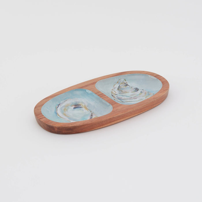 Oval wooden serving tray with oyster pattern against white background