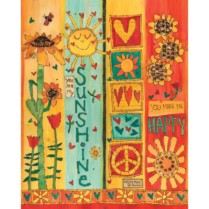 Colorful panels of an art pole with sun, heart, and peace symbol designs and text.